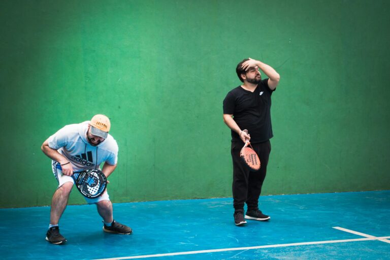 a man holding a tennis racquet on top of a tennis court